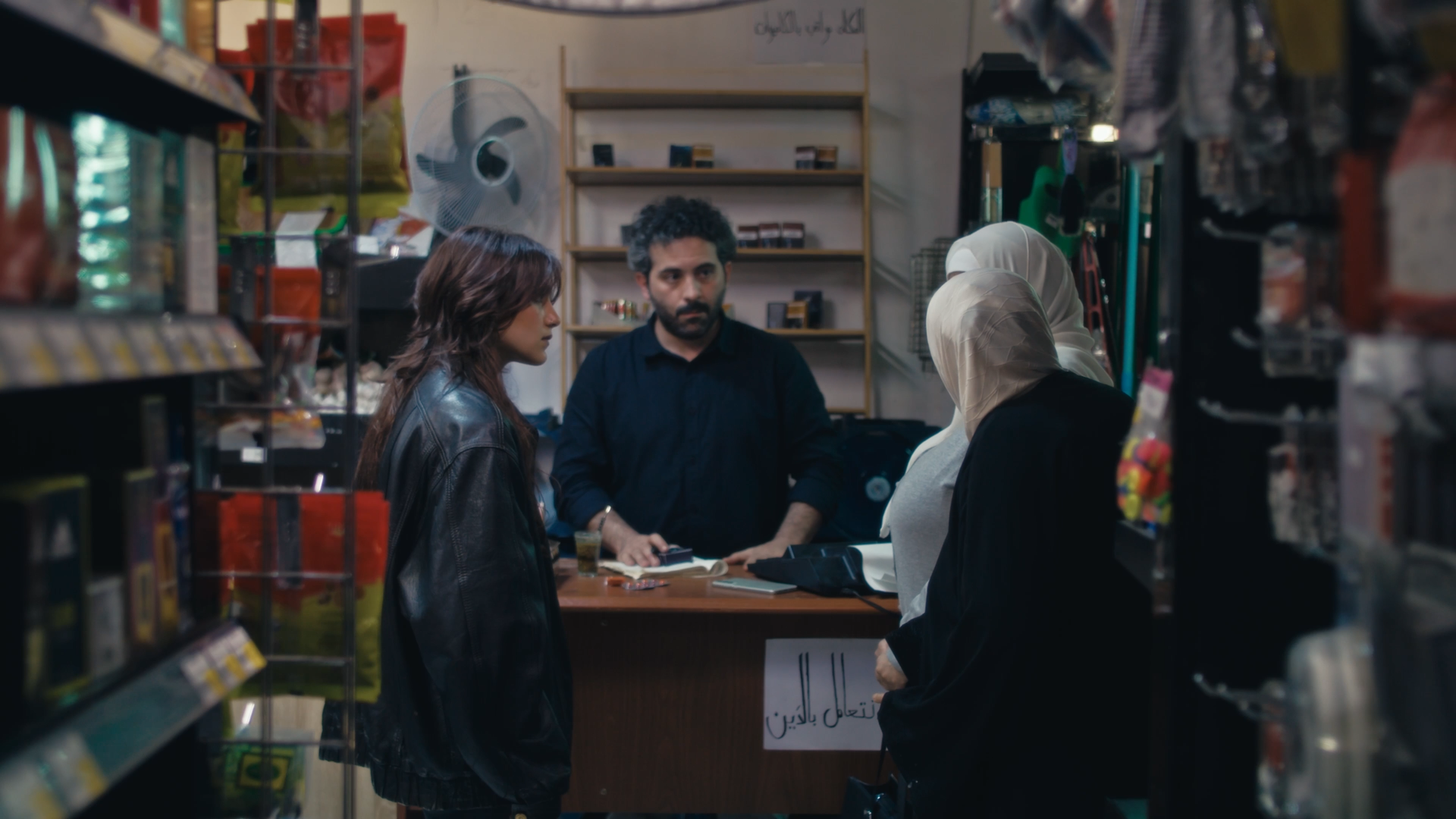 Customers gathered around a shop counter in Humbug